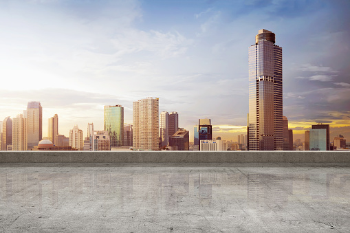 Empty rooftop floor with skyscrapers view at afternoon