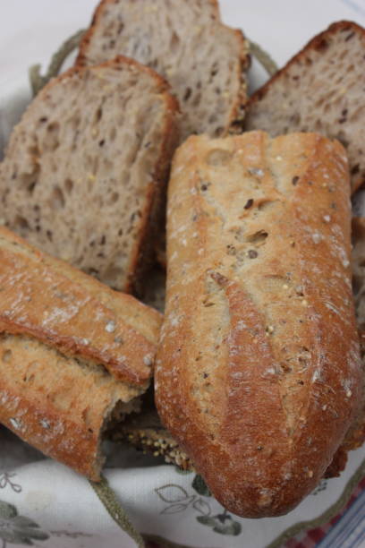 istock Bread baguette and sliced bread in a bread basket 1058629192