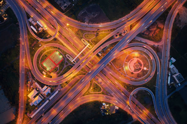 istock Aerial view of highway junctions. Bridge roads shape number 8 or infinity sign in structure of architecture concept. Top view. Urban city, Bangkok at night, Thailand. 1058633174