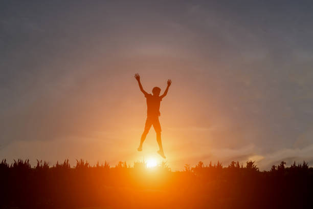 istock silhouette of a happy people and sunset 1058633414
