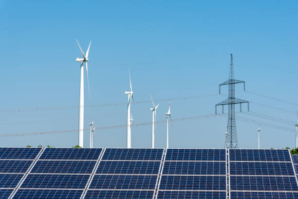 istock Electricity pylons, solar panels and wind turbines 1058634892