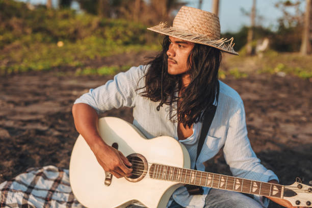 istock Handsome man playing acoustic guitar 1058635300