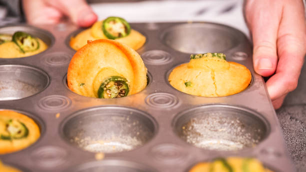 istock Taking out freshly baked spicy jalapeno cornbread muffins 1058636684