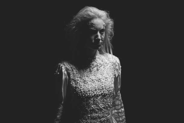istock Scary witch standing in the dark 1058640656