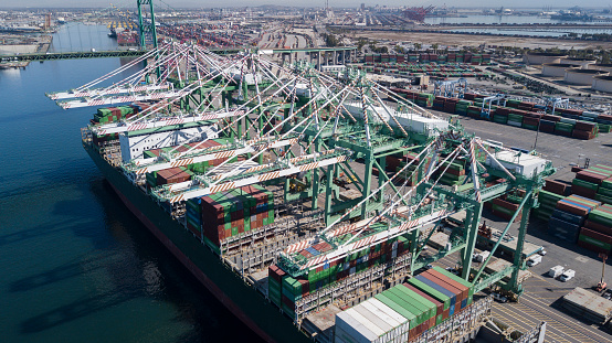 Aerial views of a cargo ship being unloaded at the Port of Los Angeles.