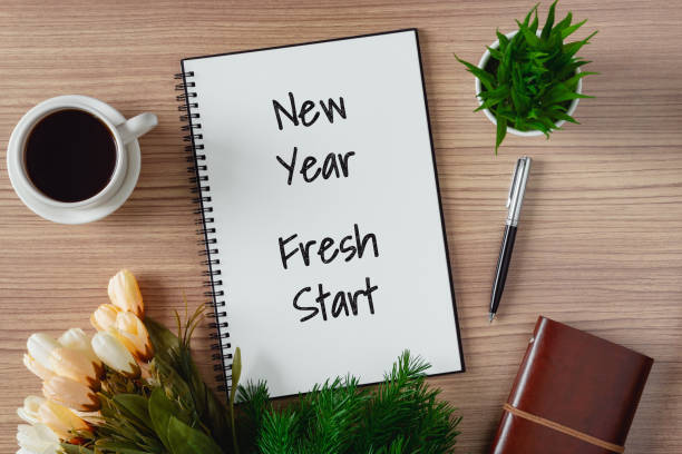 Notepad with wish list and coffee cup. New year's hope and resolution concept. Notepad with wish list and coffee cup. New year's hope and resolution concept - New Year, Fresh Start. 2019 new year resolution stock pictures, royalty-free photos & images