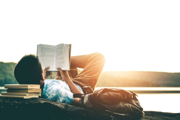 istock Men read books in quiet nature, concept read a books. 1058643068