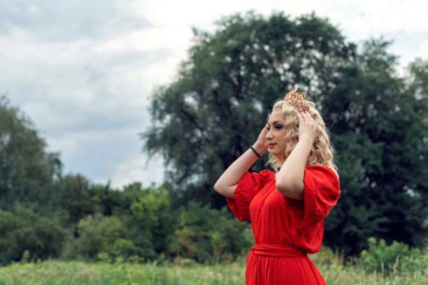 istock Blonde with curly hair in the park 1058644510