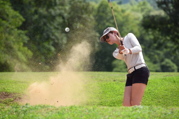 istock Asian woman golfer hitting a bunker shot 1058644698