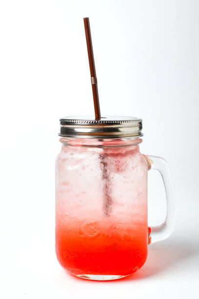 istock Ice red  drinks soda water in clear glass bottle on white background 1058644942