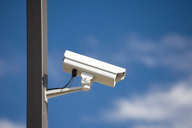 surveillance camera on light pole stock photo