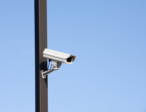 surveillance camera on light pole in parking lot