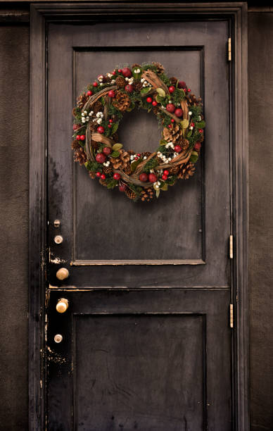 istock Black door hanging a Christmas Wreath. 1058650548