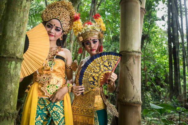 istock Young traditional Bali dancers in a bamboo forest 1058652332