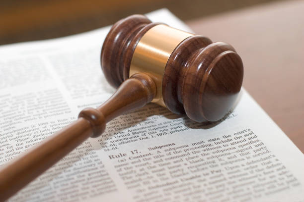 istock Subpoena over an open book forming law symbol 105865238
