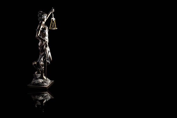 istock Lady justice or Themis with reflection isolated on black background and space for text 1058658544