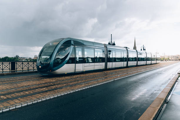 istock Modern city tram crossing bridge after rain 1058659820