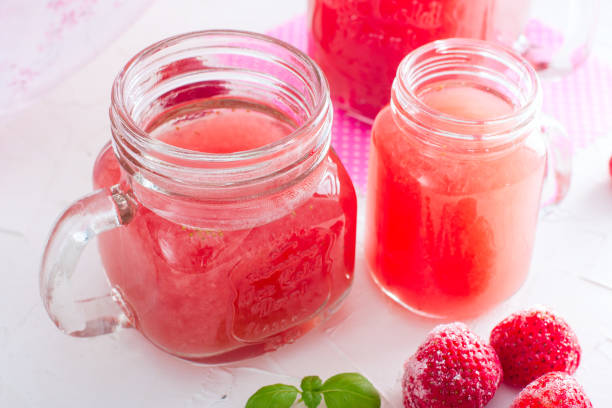 istock Traditional Russian drink-Kisel (from frozen strawberry) on a white table in glass glasses, horizontal 1058660004