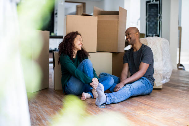 istock Smiling couple talking while relaxing in new home 1058660468