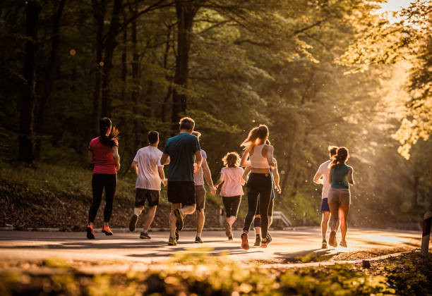 istock Rear view of marathon runners racing at sunset. 1058660682