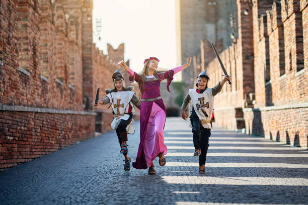 Princes and her knights running through castle courtyard Kids dressed as as knights and princess are running happily through castle courtyard. Shot on public Verona bridge, not castle.
Nikon D850. knight person photos stock pictures, royalty-free photos & images