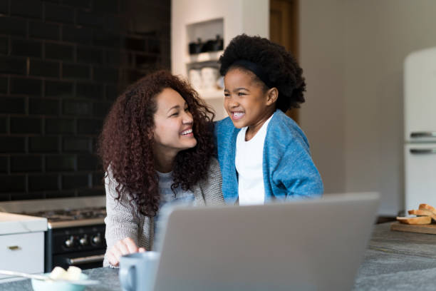 istock Happy young mother looking at daughter in kitchen 1058669032