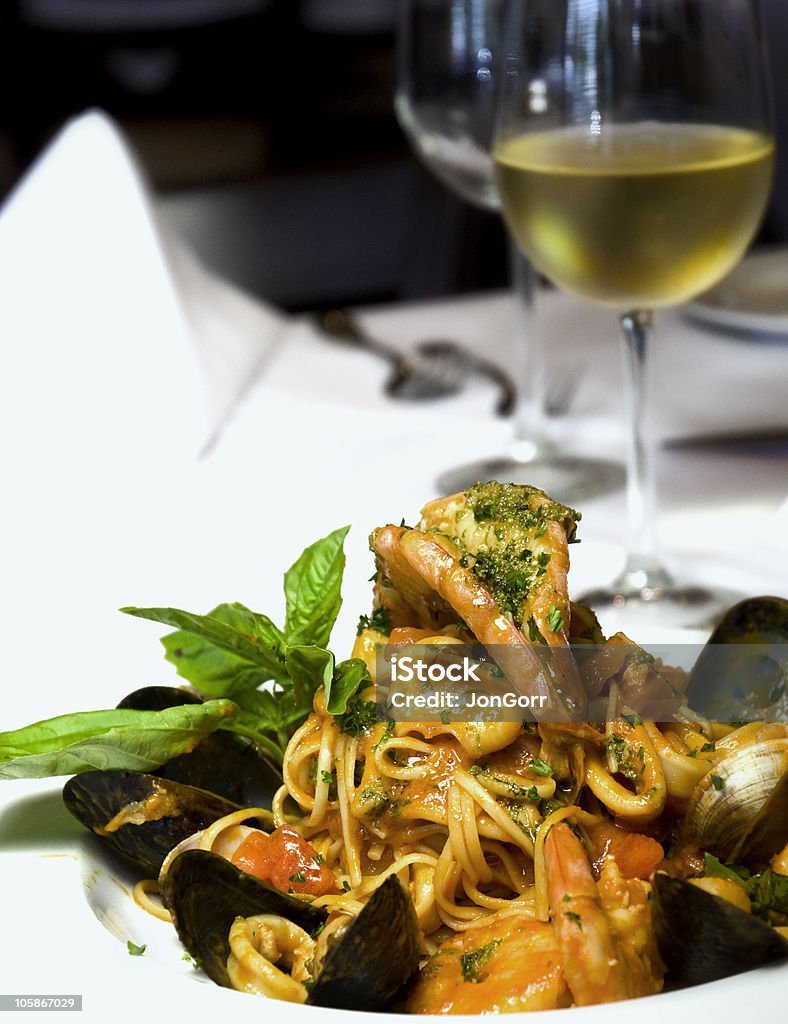 Fine Dining With Seafood Medley And White Wine Animal Shell Stock Photo