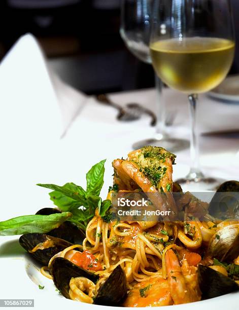 Fine Dining With Seafood Medley And White Wine Stock Photo - Download Image Now - Animal Shell, Basil, Calamari