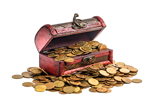 old wooden chest in chains on a pile of gold coins. isolated on white.