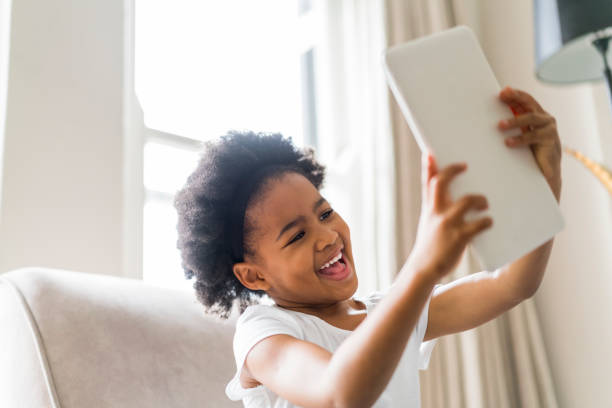 istock Cheerful girl taking selfie with digital tablet 1058683938
