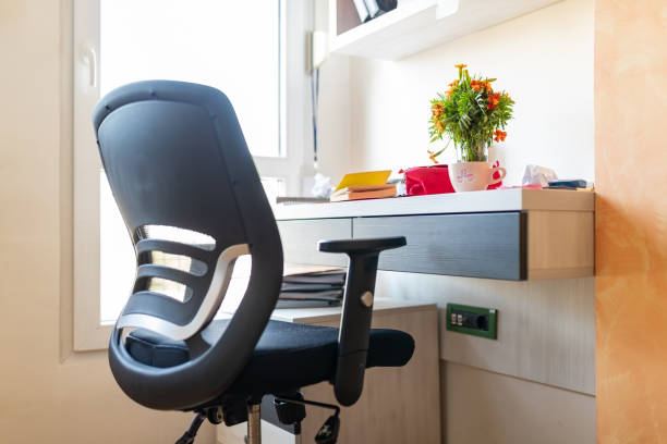 Office chair at the studying desk Black ergonomic office chair at the studying desk ergonomics photos stock pictures, royalty-free photos & images