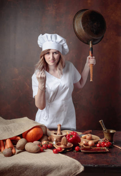 istock Very angry chef with big frying pan in hand. 1058684494
