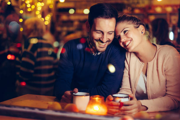 Romantic couple dating in pub at night Romantic young couple dating in pub at night date night romance stock pictures, royalty-free photos & images