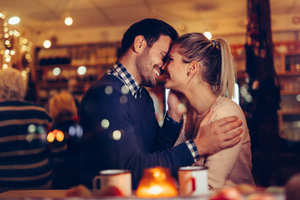 istock Romantic couple dating in pub at night 1058684920