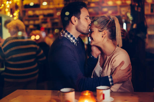 istock Romantic couple dating in pub at night 1058684930