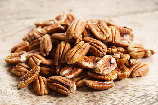 Pecan nuts on wooden background