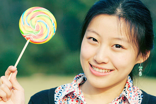 istock young asian girl with Lollipop 105868499