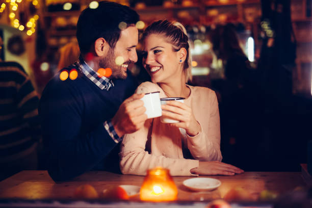 istock Romantic couple dating in pub at night 1058685340