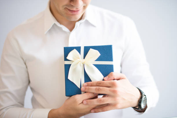 istock Closeup of positive man embracing gift box 1058687440