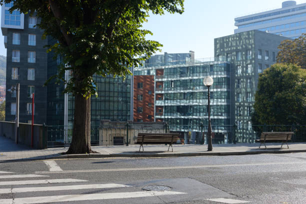 istock Sun reflection on modern glass skyscraper facade and street 1058687518
