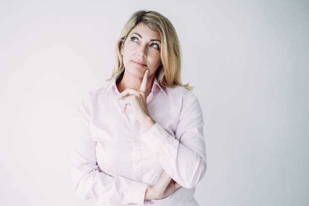 istock Pensive Middle-aged Woman Touching Chin 1058692012