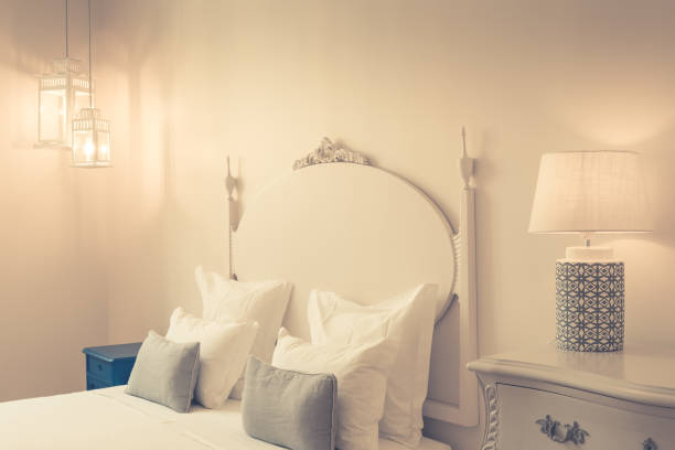 istock bedroom in soft light colors. big comfortable double bed in elegant classic bedroom 1058692576