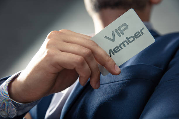 VIP member card holded by an elegant man in suit. stock photo