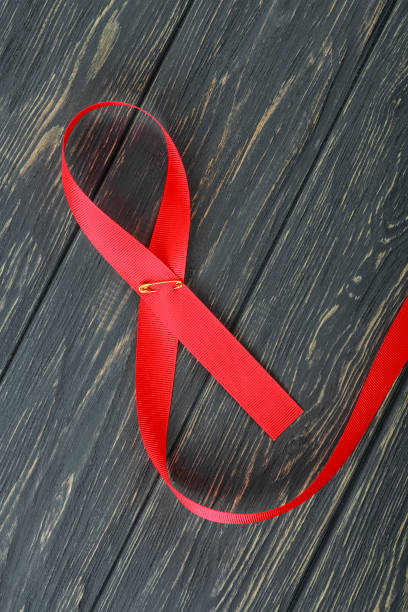 istock Red ribbon on the wooden background 1058693070
