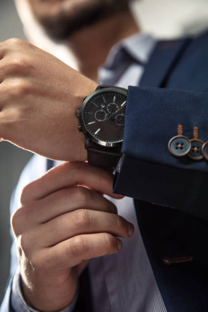 istock Elegant man with suit and watch on hand. 1058694306