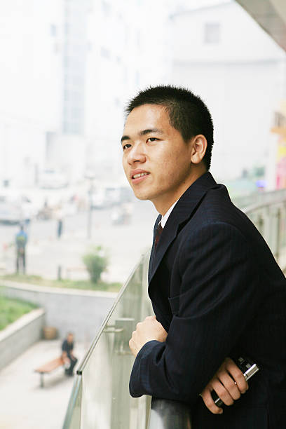 young businessman holding mobile phone