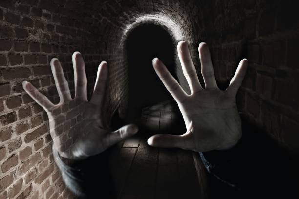 Creepy hand in the dark cell Double exposure exorcism stock pictures, royalty-free photos & images