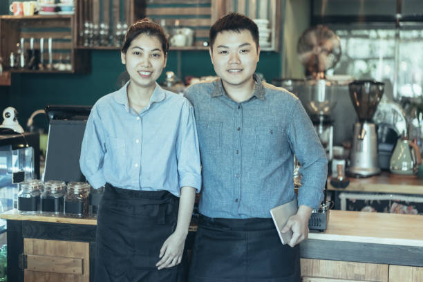 istock Cheerful coffee shop staff working together 1058697534