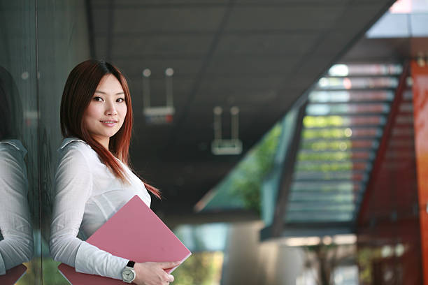 istock young business woman holding document 105869816