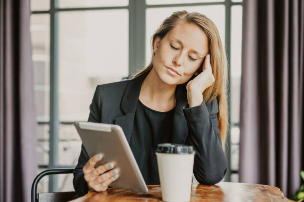 istock Tired Business Lady Using Tablet at Cafe Table 1058699976